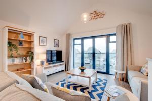 a living room with a couch and a table at 2 Bed in Westward Ho oc-idleho in Northam