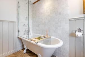 a white bathroom with a tub and a shower at 3 Bed in Scarborough oc-sa004 in Ravenscar +39 photos