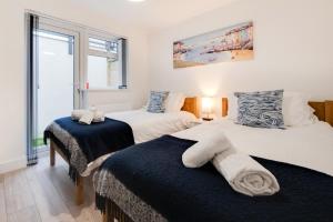 a bedroom with two beds and a window at 3 Bed in Looe oc-l30071 in Looe