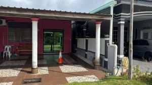 a porch of a house with columns and a porch at Studio Khalida Taman Perdana in Pekan +8 photos
