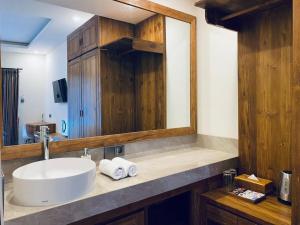 a bathroom with a sink and a mirror at Indarti Living in Sukawati +12 photos