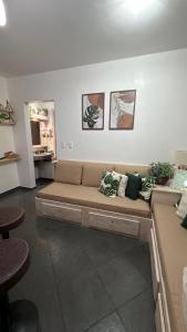 a living room with a couch in a room at Flat Piemonte Apart in Serra Negra