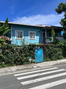 a blue house on the side of a street at Boho Pelicano in Bocas Town