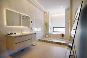 a bathroom with a sink and a mirror at ALVILLA Kampung Cina in Kuala Terengganu