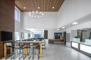 a kitchen and dining room with a bar and chairs at Holiday Inn Express San Diego - Sea World Area by IHG in San Diego