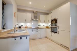 a kitchen with white cabinets and a sink at 2 Bed in Windermere oc-gl064 in Windermere +7 photos