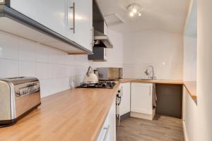 a kitchen with white walls and wooden counter tops at 2 Bed in Whitby oc-r563 in Robin Hood's Bay