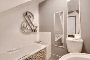 a white bathroom with a toilet and a mirror at 2 Bed in Whitby oc-r563 in Robin Hood's Bay