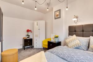 a bedroom with a bed and a yellow chair at 2 Bed in Whitby oc-r563 in Robin Hood's Bay