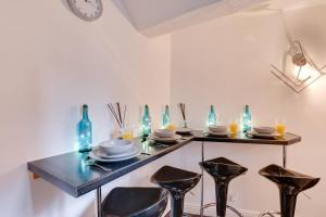 a table with chairs and blue bottles and glasses at 2 Bed in Whitby oc-r563 in Robin Hood's Bay +4 photos