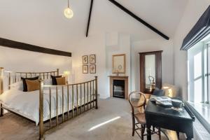 a bedroom with a bed and a table and a desk at 3 Bed in Bessingham oc-b28837 in Thurgarton