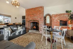 a living room with a couch and a brick fireplace at 3 Bed in Bessingham oc-b28837 in Thurgarton +8 photos
