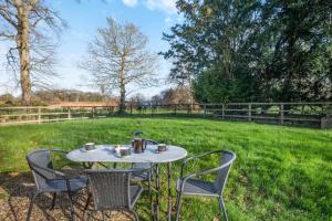 a table with two chairs and a tea pot on it at 3 Bed in Bessingham oc-b28837 in Thurgarton