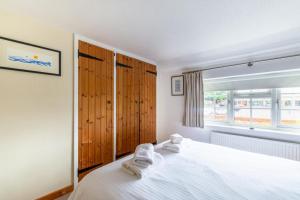 a bedroom with a white bed and a window at 1 Bed in Holt oc-1838 in Holt