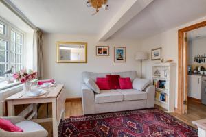 a living room with a couch and a table at 1 Bed in Holt oc-1838 in Holt