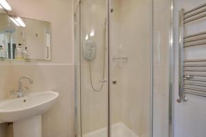 a bathroom with a glass shower and a sink at 4 Bed in Buxton oc-dcjar in Tideswell