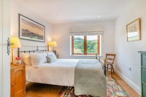 a bedroom with a large bed and a window at 3 Bed in Withypool oc-o18550 in Withypool