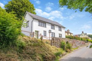 a white house on the side of a hill at 3 Bed in Withypool oc-o18550 in Withypool