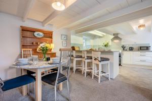 a kitchen and dining room with a table and chairs at 2 Bed in St. Teath oc-shilli in Saint Teath +18 photos