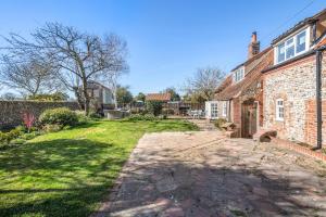 an exterior view of a brick house with a yard at 2 Bed in Wiveton oc-g29762 in Wiveton