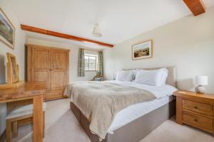 a bedroom with a bed and a desk and a television at 3 Bed in Carperby oc-ds1033 in Carperby