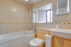 a bathroom with a tub and a toilet and a sink at 3 Bed in Carperby oc-ds1033 in Carperby +22 photos