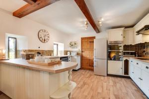 a kitchen with white appliances and a clock on the wall at 3 Bed in Carperby oc-ds1033 in Carperby