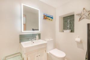 a bathroom with a sink and a toilet and a mirror at 2 Bed in Holt oc-2027 in Thornage +7 photos