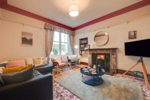 a living room with a couch and a fireplace at 6 Bed in Keswick oc-ld177 in Keswick