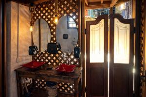 a room with a wooden table and a door at Vilarejo Hospedagem in Ilha do Mel +33 photos