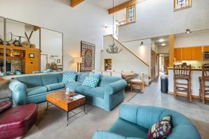 a living room with blue couches and a table at Evergreen Condominiums by Vail Resorts in Keystone