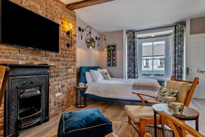 a bedroom with a bed and a brick wall at 4 Bed in Ruthin oc-a29543 in Ruthin