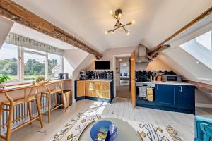 a kitchen with blue cabinets and a large window at 4 Bed in Ruthin oc-a29543 in Ruthin