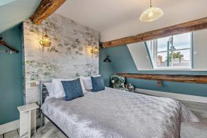 a bedroom with a bed with blue walls and a window at 4 Bed in Ruthin oc-a29543 in Ruthin