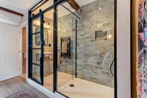 a glass shower in a bathroom with a brick wall at 4 Bed in Ruthin oc-a29543 in Ruthin +44 photos