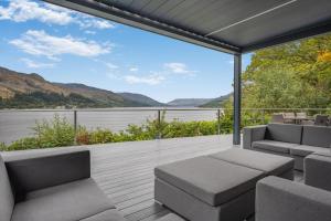 a balcony with a view of the water and mountains at 5 Bed in St. Fillans oc-t30058 in Saint Fillans