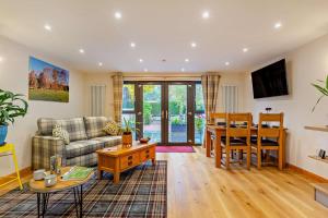 a living room with a couch and a table at 1 Bed in Strathpeffer oc-h30077 in Strathpeffer