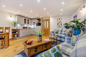 a living room with a couch and a table at 1 Bed in Strathpeffer oc-h30077 in Strathpeffer