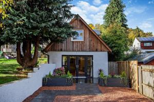 a small house with a wooden roof at 1 Bed in Strathpeffer oc-h30077 in Strathpeffer