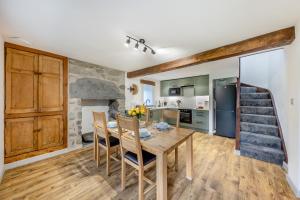 a kitchen and dining room with a table and chairs at 2 Bed in Penmaenpool oc-m30050 in Arthog