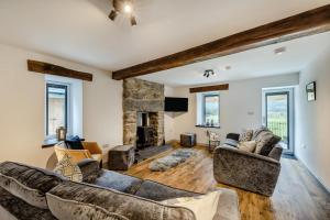 a living room with two couches and a fireplace at 2 Bed in Penmaenpool oc-m30050 in Arthog