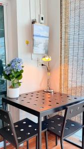 a table with two chairs and a lamp on it at Softbox Hostel in Ban Laem Thong Lang