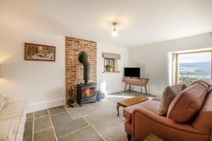 a living room with a couch and a fireplace at 2 Bed in Cowling oc-l30774 in Cowling
