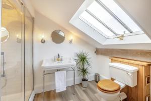 a bathroom with a toilet and a sink and a skylight at 2 Bed in Cowling oc-l30774 in Cowling +25 photos