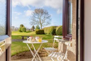a table with two glasses of orange juice sitting on a porch at 2 Bed in Insch oc-t30986 in Colpy