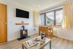 a living room with a fireplace and a table at 2 Bed in Insch oc-t30986 in Colpy