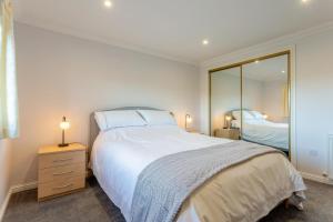 a bedroom with a large white bed and a mirror at 2 Bed in Insch oc-t30986 in Colpy