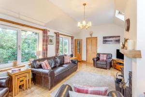 a living room with a leather couch and chairs at 3 Bed in Isle Of Skye oc-r31786 in Broadford