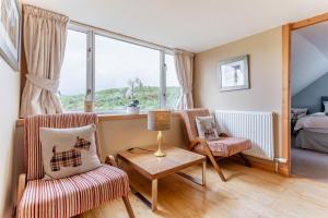 a room with two chairs and a table and a window at 3 Bed in Isle Of Skye oc-r31786 in Broadford