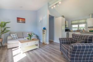 a living room with two couches and a kitchen at 2 Bed in Bush oc-b31845 in Bude +20 photos